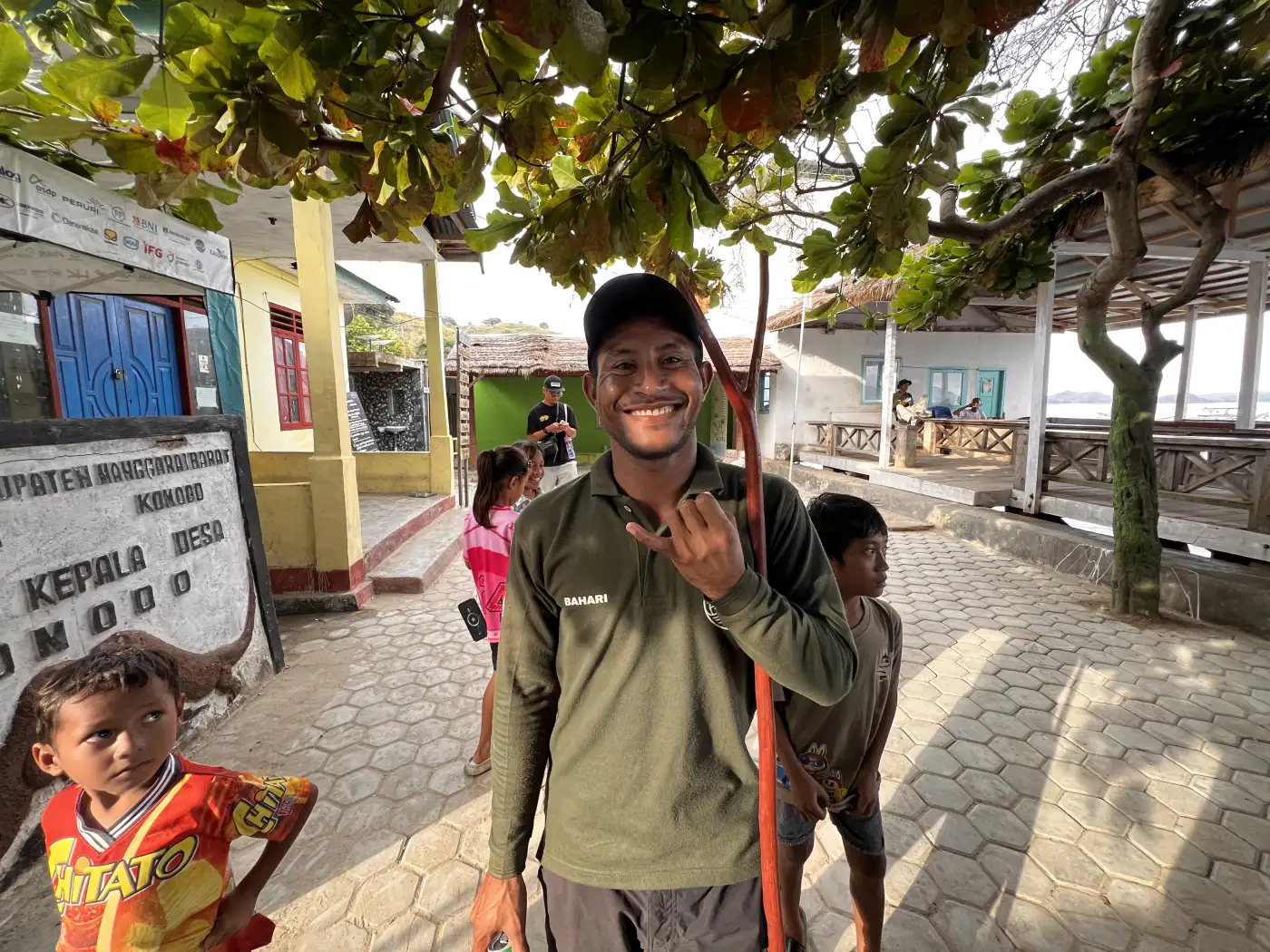A local Komodo Village guide carrying a wooden walking stick.