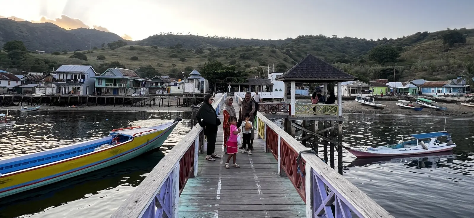 Pak Alyas with his family on the Komodo Village jetty.